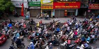 HANOI, VIETNAM - MAY 19: Motorbike riders with face masks are stuck in traffic during the morning peak hour on May 19, 2020 in Hanoi, Vietnam. Though some restrictions remain in place, Vietnam has lifted the ban on certain entertainment facilities and non-essential businesses, including pubs, cinemas and spas &amp; other tourist attractions to recover domestic tourism. On April 23, the Ministry of Transport started to increase domestic flights and trains to major destinations with limited passenger capacity. As of May 19, Vietnam has confirmed 324 cases of coronavirus disease (COVID-19 ) with no deaths in the country, 263 fully recovered and no new case caused by community transmission for 33 days. (Photo by Linh Pham/Getty Images)