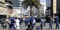 Injured demonstrators lie in the street as aprotest is driven back by riot police on 16 August 2019 in Harare, Zimbabwe. The Movement for Democratic Change called for protests against President Emmerson Mnangagwa and his government's management of the economy. Nearly two years after Mnangagwa took power, the country faced rising inflation, increased poverty and a severe water shortage. (Photo: Tafadzwa Ufumeli / Getty Images)