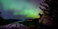  Kathryn Richer (left) and her friend Andrea gaze upon the Northern Lights at Chanticleer Point Lookout on the Columbia River Gorge in the early morning hours of May 11, 2024 in Latourell, Oregon. Places as far south as Alabama and parts of Northern California were expected to see the aurora borealis, also known as the northern lights from a powerful geomagnetic storm that reached Earth. (Photo by Mathieu Lewis-Rolland/Getty Images)