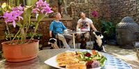 Ed Palm, Pete Bosman, Buddha calm and tail wags welcome guests for a toastie and a garden salad. (Photo: Wanda Hennig)<br>