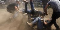 Men hold a wild horse while they attempt to shave its horsehairs during the traditional 'Rapa das Bestas' (lit. Shaving the beasts) in Cedeira, Spain, 04 June 2023. During the weekend, men from the town strive to catch the wild horses in order to shave their hairhorse, and finally all of them are released to the wild on the next Monday.  EPA-EFE/Kiko Delgado