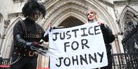 Fans in costume display a banner in support of US actor Johnny Depp outside the Royal Courts of Justice in London, Britain, 18 March 2021. EPA-EFE/NEIL HALL