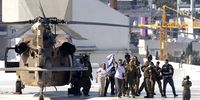 Released hostage Omri Miran waves to cheering crowd with Israeli flag, after landing at Ichilov Medical Centre following his release from Hamas captivity on 13 October 2025 in Tel Aviv, Israel. (Photo: Amir Levy / Getty Images)