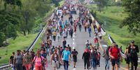 Central American migrants walk in a caravan towards the border with the United States, as they pass through Escuintla, Mexico, 09 June 2022. The migrant caravan that left on 06 June with 15,000 people from the Mexican Tapachula, bordering Guatemala, has broken up during the journey, but has not stopped its passage through southern Mexico and remains firm in its goal of reaching the United States.  EPA-EFE/Juan Manuel Blanco