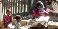 Students from the homeopath department at the University of Johannesburg explain the health treatment to Nokuthula Jali and her children at Victoria Yards. (Photo: Lungile Hlatshwayo)