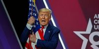 NATIONAL HARBOR, MARYLAND - FEBRUARY 29: President Donald Trump hugs the flag of the United States of America at the annual Conservative Political Action Conference (CPAC) at Gaylord National Resort &amp; Convention Center February 29, 2020 in National Harbor, Maryland. Conservatives gather at the annual event to discuss their agenda.  (Photo by Tasos Katopodis/Getty Images)