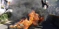  A protester stands near burning tires during a rally against alleged electoral fraud outside the parliament building ahead of the official announcement of the election result in Jakarta, Indonesia, 19 March 2024. Hundreds of protesters staged a rally demanding the impeachment of Indonesian President Joko Widodo on accusations of his involvement in the election process which they claimed were fraudulent. The election commission is expected to announce the election results on 20 March 2024.  EPA-EFE/MAST IRHAM