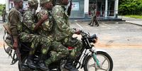 Mozambique army soldiers take a ride on a motorbike in the streets of Palma, Cabo Delgado, Mozambique, 12 April 2021. The violence unleashed more than three years ago in Cabo Delgado province escalated again about two weeks ago, when armed groups first attacked the town of Palma.  (Photo: EPA-EFE / JOAO RELVAS)