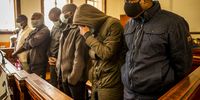 The six accused of the murder of Babita Deokaran from left to right, Phakamani Hadebe, Zitha Hadebe, Nhlangano Ndlovu, Sanele Mbele, Siphiwe Mazibuko and Phakanyiswa Dladla stand in the dock of the Johannesburg Magistrates Court. <br>Photo / Shiraaz Mohamed.
