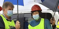 Marcel Dreyer, the UPL regional head for Africa and the Middle East and national Environment Minister Barbara Creecy huddle under umbrellas during an inspection of the Cornubia farm poisons warehouse. (Photo: Department of Forestry, Fisheries and Environmental Affairs).