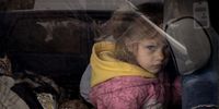 ZAPORIZHZHIA, UKRAINE - APRIL 23: A girl looks out the window of her families car after arriving at an evacuation point for people fleeing Mariupol, Melitopol and the surrounding towns under Russian control on April 23, 2022 in Zaporizhzhia, Ukraine. Ukrainian and Russian authorities, as well as international aid groups, have been engaged in fitful negotiations for weeks over the evacuation of civilians from Mariupol and other parts of southeast Ukraine under Russian assault. (Photo by Chris McGrath/Getty Images)