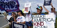 People hold signs in support of Democratic presidential nominee, Vice President Kamala Harris ahead of Republican presidential nominee, former President Donald Trump visiting for a townhall event on October 15, 2024 in Cumming, Georgia. The two candidates have scheduled multiple events in battleground states ahead of the November 5 election. (Photo by Megan Varner/Getty Images)
