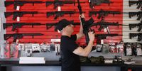 Brandon Wexler helps a customer look at weapons at WEX Gunworks on 24 March 2021 in Delray Beach, Florida. (Photo: Joe Raedle / Getty Images)