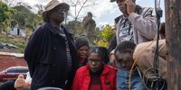 Abahlali baseMjondolo president S'bu Ndebele's wife, Sindi Mkhize, and some community members view cctv footage of gunmen entering the settlement and breaking a window using a spade before entering the house. (Photo: Siyabonga Mbhele)