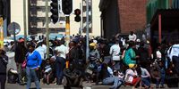 Zimbabweans wait in long queues at Home Affairs on Rissik Street In Johannesburg on 13 December 2010. Zimbabweans on special dispensation visas‚ which were issued in 2010 and expired on 31 December, were applying for  Zimbabwe Exemption Permits. (Photo: Gallo Images / The Times / Marianne Schwankhart)