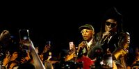 Pharrell Williams performs with Jay-Z after unveiling the collection. Photographer: Adrienne Surprenant/Bloomberg