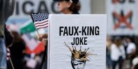 Making a point with a punning poster at a 'No Kings' protest in downtown Chicago.  (Photo: Cristobal Herrera-Ulashkevich / EPA)