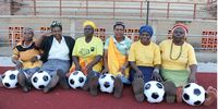South African grandmothers pose with footballs in the Nkowankowa township on November 24, 2009 in Tzaneen, South Africa. The grandmothers are part of a team called Vakhegula Vakhegula, which means "Grannies" in the local Xitsonga dialect and hope to play an exhibition game before one of the World Cup 2010 opening games. (Photo by Lefty Shivambu/Gallo Images/Getty Images)