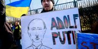 epa09784437 People carry placards as they gather to protest against Russia's military operation in Ukraine in front of the NATO headquarters in Brussels, Belgium, 25 February 2022. Russian troops entered Ukraine on 24 February prompting the country's president to declare martial law and triggering a series of announcements by Western countries to impose severe economic sanctions on Russia.  EPA-EFE/STEPHANIE LECOCQ