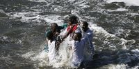 Siboniso Mdaka of the Morian Africa Church baptised by bishops and assisted  by other church members. The dipping is a very emotional experience to witness and as one Bishop said it also signifies washing away people’s sins was and is also a way of welcoming some members into the church. Photo: Felix Dlangamandla