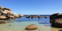 On my Sunday morning bike ride I made a stop at Oude Kraal, between Hout Bay and Camps Bay. I was struck by this tranquil rock-strewn beach and took a (very cold) swim. Photographer: Herman Hintzen<br>