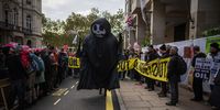 Climate activists take part in an anti-oil protest outside the Intercontinental Hotel on October 17, 2023 in London, England. Activists join an environmental protest as the Energy Intelligence Forum conference takes place in Mayfair. (Photo by Carl Court/Getty Images)
