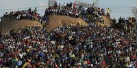 Family members and members of Wonderkop informal settlement gather on a hillside overlooking the scene of the massacre following a memorial service held in honour of Lonmin mineworkers who were killed by police on 16 August 2012. (Photo: EPA / STR)