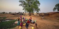 MIRZAPUR, INDIA - MAY 20: Villagers gather to collect water from a malfunctioning hand pump on May 20, 2022, in Garhwa village, 60 kms (37 miles) from Mirzapur, Uttar Pradesh, India. A severe heatwave has caused drought-like conditions in vast swathes of India's agricultural heartlands from north to south, as the rains that usually arrive before the country's prolonged monsoon season have so far failed to materialize in many regions. India is particularly vulnerable to drought as its under-developed agriculture sector is heavily dependent on timely, uninterrupted natural weather cycles for its survival. About 150 villages in the Mirzapur region are facing extreme water crisis. Most of the water is supplied by tankers and there is a daily quota of 15 litres per person. Due to this, many residents end up drinking water from unhygienic sources, causing Diarrhea and other related diseases. (Photo by Ritesh Shukla/Getty Images)