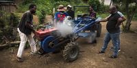 Community members stand around a tractor that was donated. The tractor is a valuable asset for the community in terms of garden work. (Photo: Shiraaz Mohamed)
