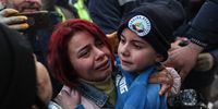 epa10453977 Eight-year-old Yigit Cakmak (R) is held by his mother after being rescued from the site of a collapsed building, some 52 hours after a major earthquake, in Hatay, Turkey, 08 February 2023. More than 7,000 people have died and thousands more injured after two major earthquakes struck southern Turkey and northern Syria on 06 February. Authorities fear the death toll will keep climbing as rescuers look for survivors across the region.  EPA-EFE/ERDEM SAHIN
