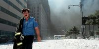 NEW YORK - SEPTEMBER 11:  An unidentified New York City firefighter walks away from Ground Zero after the collapse of the Twin Towers September 11, 2001 in New York City. The World Trade Center's Twin Towers and the Pentagon were attacked by terrorists using commercial airliners as missiles.  (Photo by Anthony Correia/Getty Images)