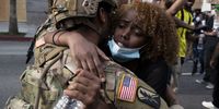 LOS ANGELES, CALIFORNIA - JUNE 2: A demonstrator hugs a member of the National Guard during a march in response to George Floyd's death on June 2, 2020 in Los Angeles, California. Floyd died while in Minneapolis police custody on May 25. Officer Derek Chauvin and three other policemen involved in the incident have been fired from the force. Chauvin has since been arrested and charged with third degree murder. Huge peaceful protests, many marred by vandalism and police violence, are taking place throughout the United States. (Photo by Brent Stirton/Getty Images)