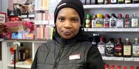 Boniswa Sobetwa, a cashier at the Tops at Spar in Observatory, Cape Town, says this Women's Day does not feel like a holiday due to the ongoing taxi strike. Her daily commute to work has gone from 20 minutes to about four hours. (Photo: Tamsin Metelerkamp)