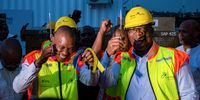 Joburg Mayor Kabelo Gwamanda (right) and Gauteng Premier Panyaza Lesufi cutting the ribbon at the launch of the Amarasta microgrid electrification project in Alexandra, Johannesburg. (Photo: Julia Evans)