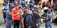 Mbuyiseni Ndlozi and SAPS during the national shutdown protest  on March 20, 2023 in Pretoria, South Africa. The Economic Freedom Fighters (EFF) are demanding an end to load shedding and the resignation of President Cyril Ramaphosa. (Photo: Gallo Images / Frennie Shivambu)