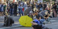 Activists shield themselves during protests in Los Angeles on 8 June. (Photo: Alison Dinner / EPA-EFE)