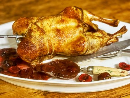 Rotisserie duck with rhubarb and cherries