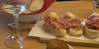 Fresh green and flinty Ribolla matched with rolls of local prosciutto. (Photo: Margot Patterson) 
