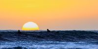 [Melkbos surfers spying for the last ride]. Photographer: [Hennie Bester]. 