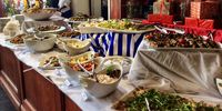 The starters table at the Greek feast includes taramasalata, seen next to the marinated peppers. Photo: Wanda Hennig