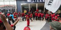EFF members protest outside a shut Clicks store in Mall Of Africa, Midrand, Johannesburg. The protest entered into its second day. Clicks has obtained an interim order against EFF members which blocks them from Òintimidating and threateningÓ Clicks employees, however the interdict however does not prevent EFF members from protesting. (Photo: Shiraaz Mohamed)