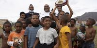 CEO of local NGO the Guardians of the National Treasure, Ralph Bouwers (back left) and former Springbok hooker Dale Santon (back middle) with children from Lavender Hill in Cape Town on Saturday 13 November 2021. An event in the area was held on World Kindness Day, which was a collaboration between food rescue organization SA Harvest Lavender Hill NGO, Guardians of the National Treasure, and members of The SA Rugby Legends. (Photo: Leila Dougan)