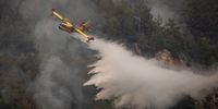 MUGLA, TURKEY - AUGUST 04: A spanish hydroplane drops water on a fire burning in Koycegiz on August 04, 2021 in Mugla, Turkey. Large wildfires continue to burn across Turkey's southern coast for the seventh day. The death toll from the fires currently stands at eight according to Turkey's Health Ministry.  (Photo by Chris McGrath/Getty Images)