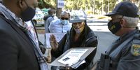 Police interact with the Southern Africa Human Rights Defenders Network during their picket at the High Commission of Mozambique in Pretoria. (Photo: Felix Dlangamandla)