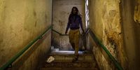 Rasta (last name unknown) walks down a stair case as he makes his way to his room.<br>(Photo: Shiraaz Mohamed)