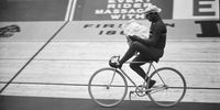 2nd May 1938:  Albert Buysse of Belgium reading a newspaper as he cycles round the track during the neutralisation period at the International Six-Day Cycle race at the Empire Pool, Wembley, London.  (Photo by A. Hudson/Topical Press Agency/Getty Images)