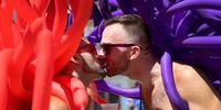 MIAMI BEACH, FLORIDA - SEPTEMBER 19:  Jimmy Serrano (L) and Jamieson Cox kiss before the start of the Miami Beach Pride Parade along Ocean Drive on September 19, 2021 in Miami Beach, Florida. The annual event was canceled in 2020 and postponed for five months this year due to the COVID-19 pandemic. (Photo by Joe Raedle/Getty Images)