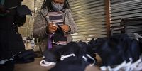 Grace Chauke prepares the masks for packaging. (Photo: Shiraaz Mohamed)