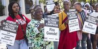 United Behind protest outside Parliament during the appearance of former Eskom CEO Andre de Ruyter before the Parliamentary Committee on 26 April, 2023 in Cape Town, South Africa. (Photo: Gallo Images/Brenton Geach/Gallo Images)