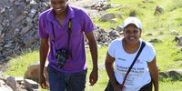 A file photo from 2014 of Mluleki Marongo and Thandeka walking in the hills near Mqanduli in the Eastern Cape. At the time Marongo was a researcher at SECTION27, he is now an advocate in Johannesburg. Thandeka often worked with journalists, researchers and activists to access residents and health workers. (Photo supplied: Treatment Action Campaign)